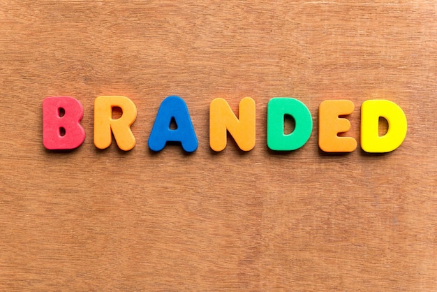 Photo directly above shot of colorful alphabets making branded text on table