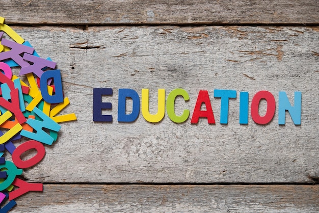 Photo directly above shot of colorful education text with letters on wooden table