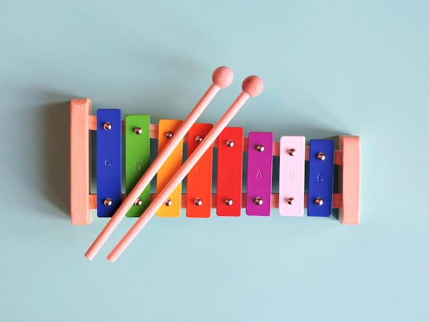 Photo directly above shot of colorful musical instrument on blue table