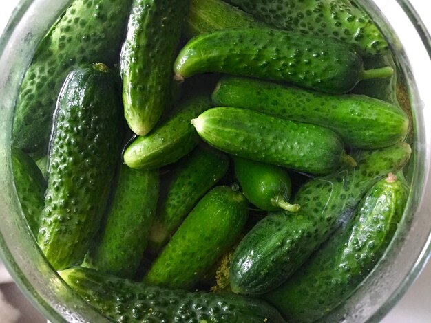 Directly above shot of cucumbers soaked in container