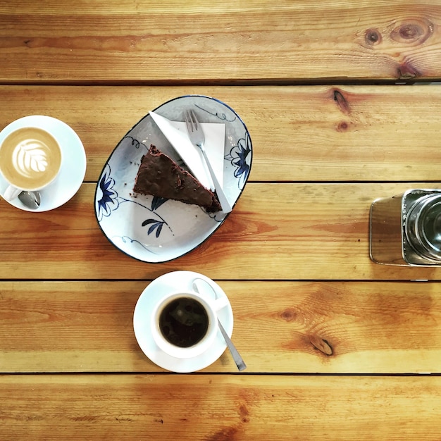 Photo directly above shot of dessert with coffees served on table