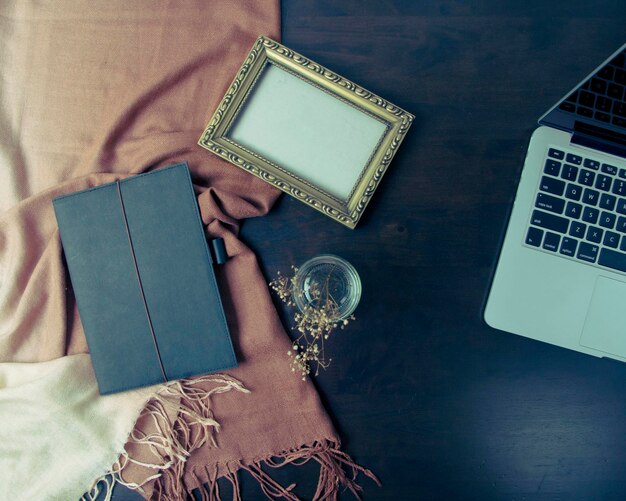 Photo directly above shot of diary and picture frame on table