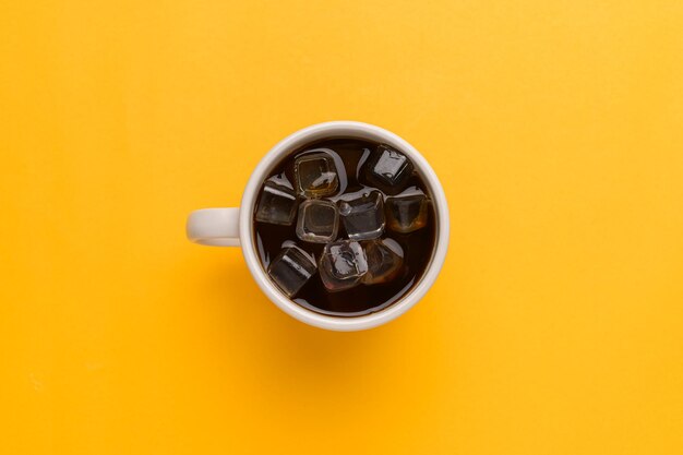 Directly above shot of drink against yellow background