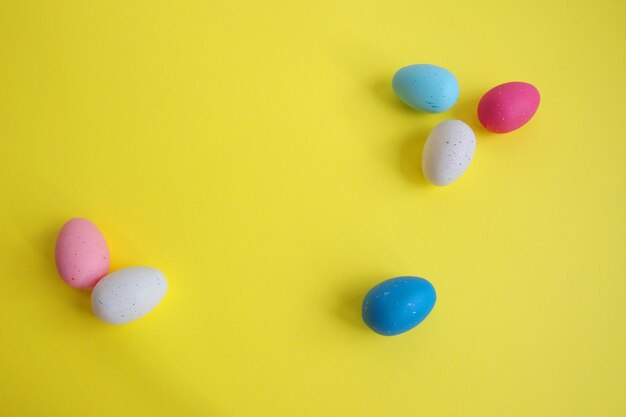 Directly above shot of easter eggs against the yellow background