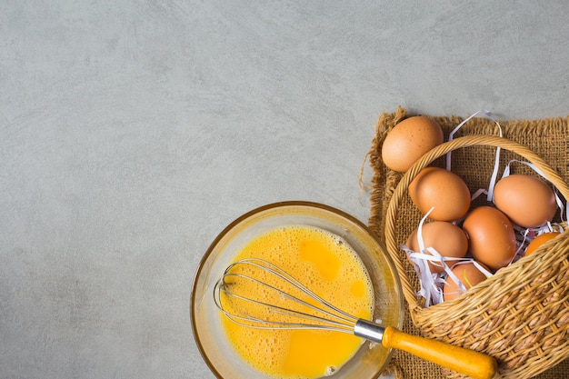 directly above shot of eggs with kitchen utensils on table