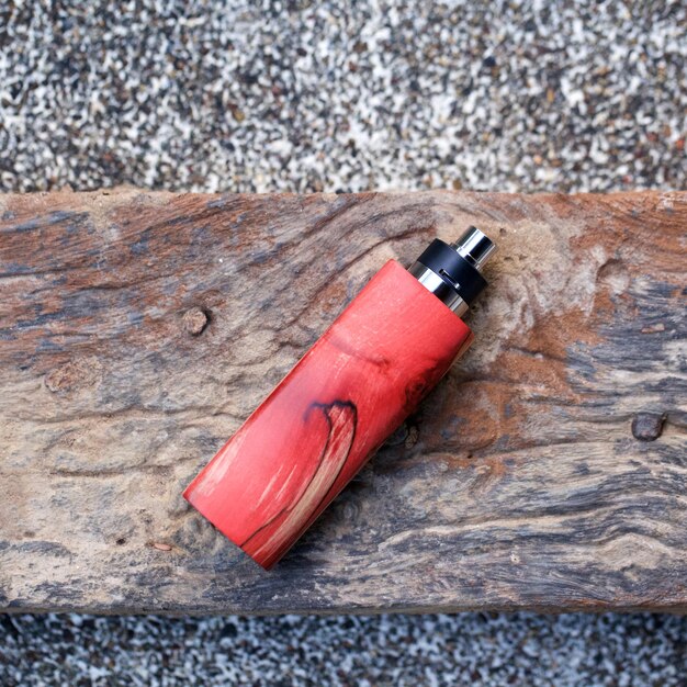 Photo directly above shot of electronic cigarette on wooden table