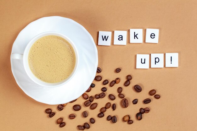 Photo directly above shot of empty cup by wake up text against brown background