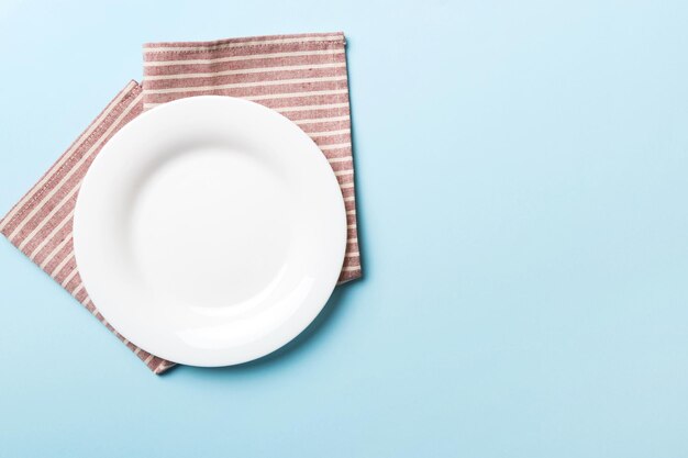 Photo directly above shot of empty plate on blue background