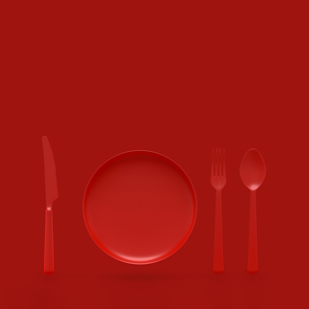 赤い背景に食器が付いている空の皿の直接上のショット