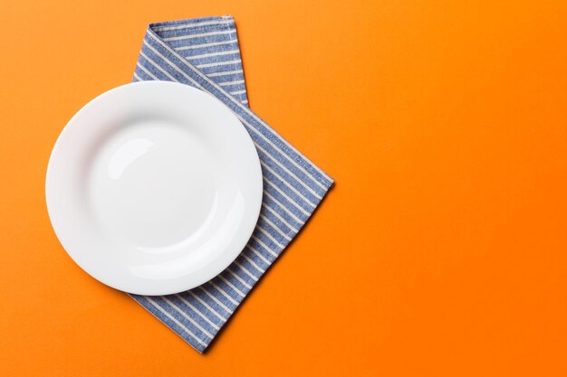 Directly above shot of empty plate on yellow background