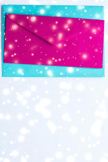 Directly above shot of envelope with glitter over white background