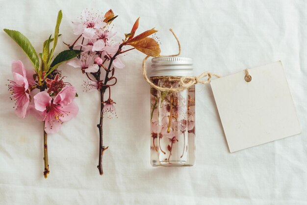 Directly above shot of essential oil and flowers on table