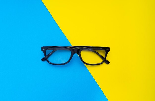 Directly above shot of eyeglasses on colored background