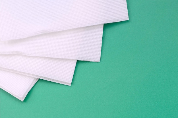 Photo directly above shot of fanned out tissue papers on green background