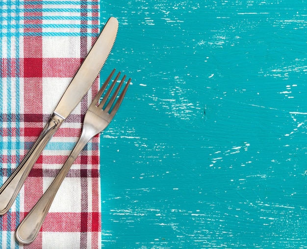 Foto direttamente sopra il colpo di forchetta e coltello sul panno sul tavolo