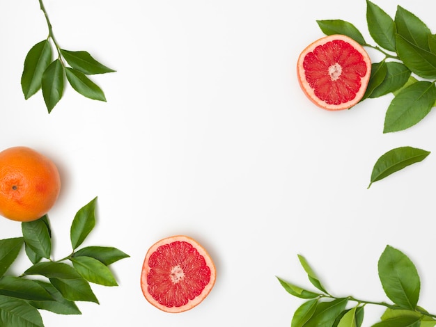 Photo directly above shot of fruits and leaves against white background