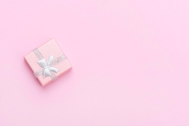 Photo directly above shot of gift box over pink background