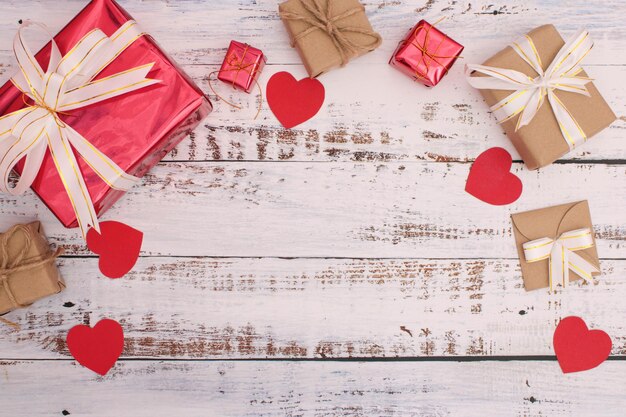 Directly above shot of gift boxes and red heart shape on table