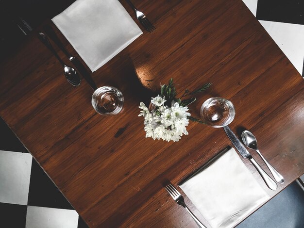 Photo directly above shot of glasses by flowers on table