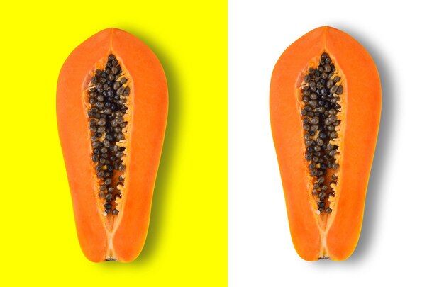 Directly above shot of halved papayas over colored background