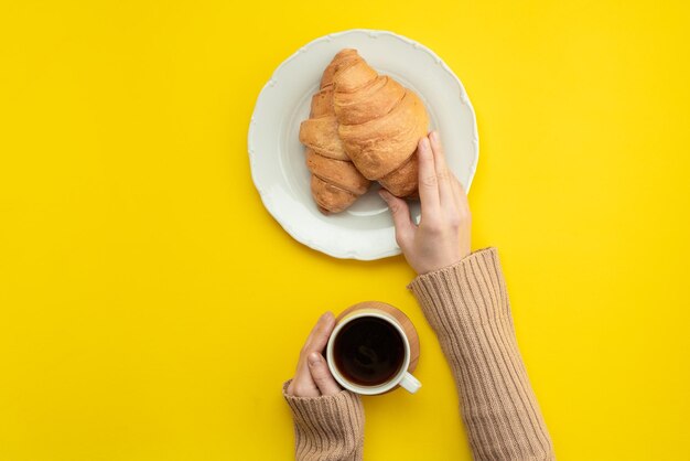 Directly above shot of hand holding coffee cup