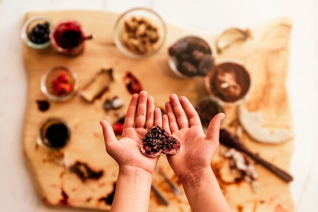 Directly above shot of hand holding fruit on table