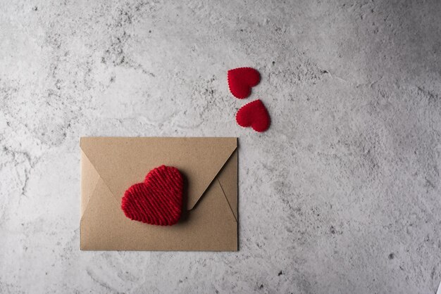 Directly above shot of heart shape and envelope over table