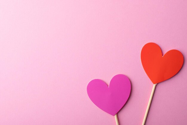 Directly above shot of heart shapes on pink background