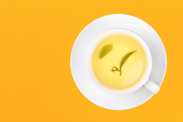 Directly above shot of herbal tea on yellow background