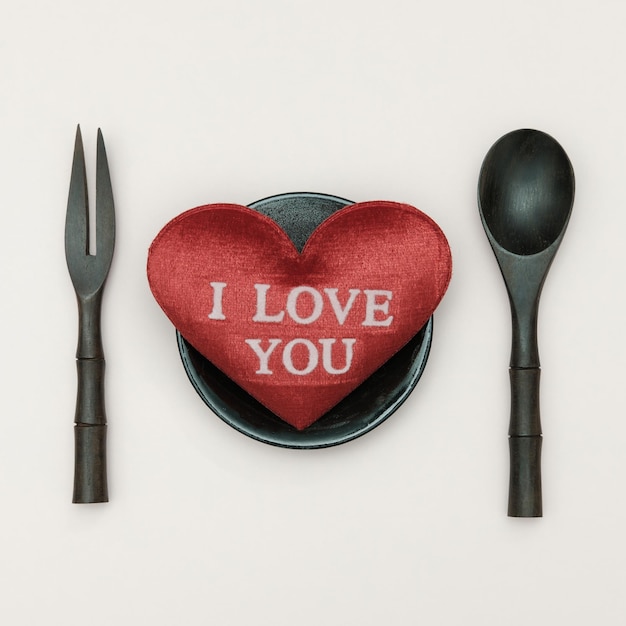 Photo directly above shot of i love you text on heart shape over colored background