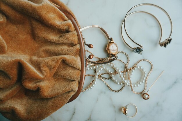 Directly above shot of jewelry by purse on table