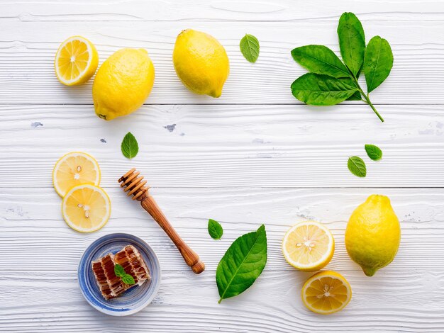 Photo directly above shot of lemons and leaves on white table