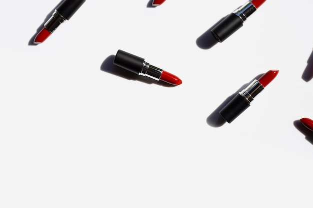 Photo directly above shot of lipsticks over white background