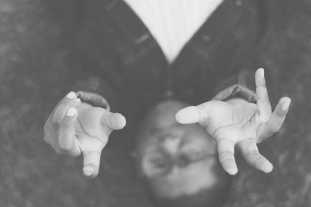 Photo directly above shot of man gesturing while lying down on floor