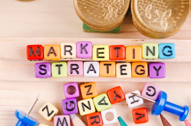 Photo directly above shot of marketing strategy text on toy blocks at table