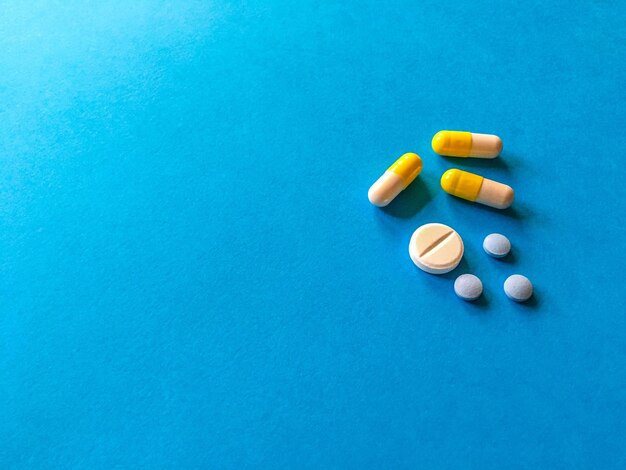 Photo directly above shot of medicines on blue background