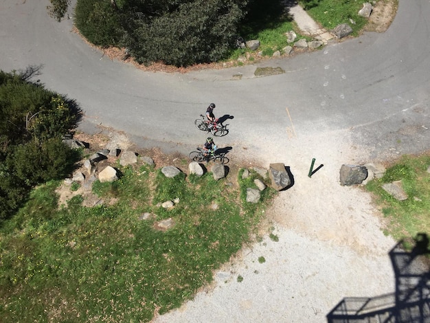 Photo directly above shot of men with bicycles on road