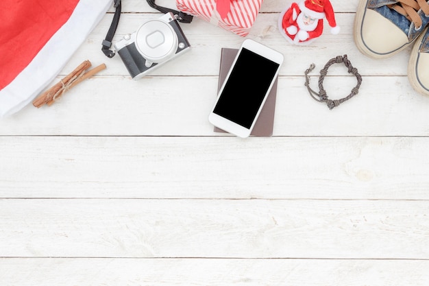 directly above shot of mobile phone and camera on table during christmas