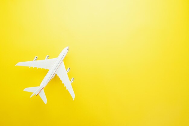 Photo directly above shot of model airplane over yellow background