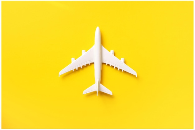 Directly above shot of model airplane over yellow background