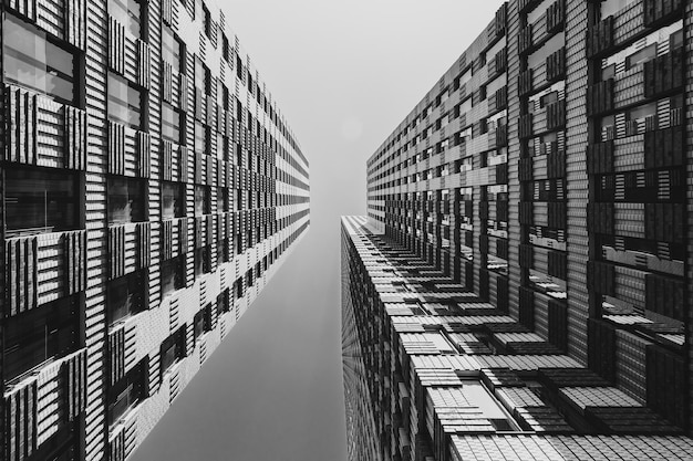 directly below shot of modern buildings against clear sky