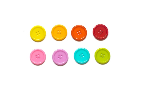 Photo directly above shot of multi colored buttons against white background