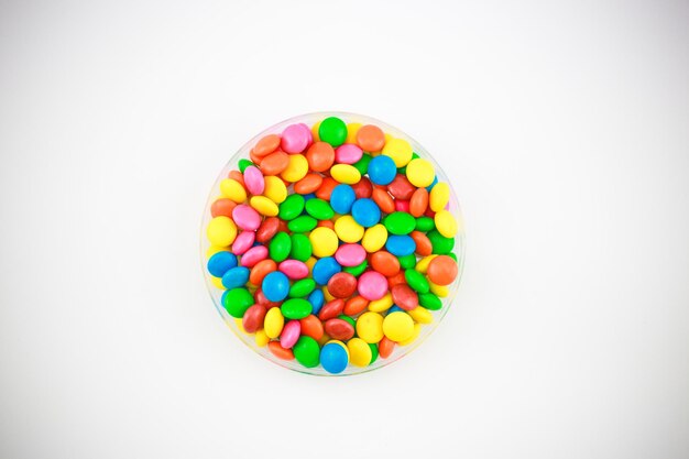 Photo directly above shot of multi colored candies against white background