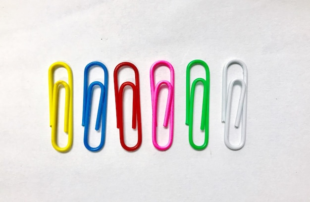 Directly above shot of multi colored paper clips on gray background