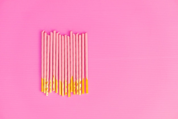 Photo directly above shot of multi colored pencils against pink background