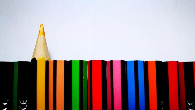 Photo directly above shot of multi colored pencils against white background