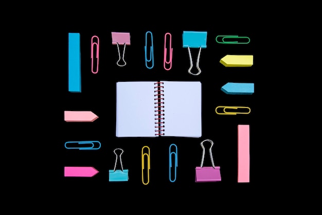 directly above shot of office supplies against black background