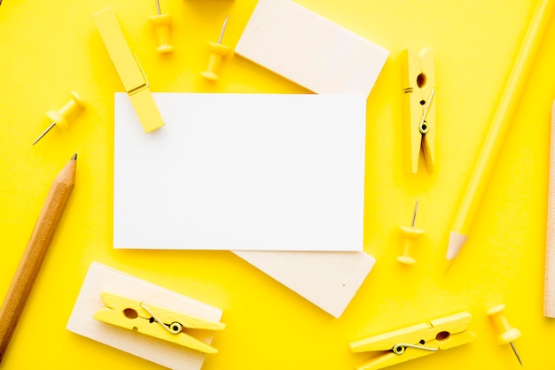 Directly above shot of office supplies on yellow background