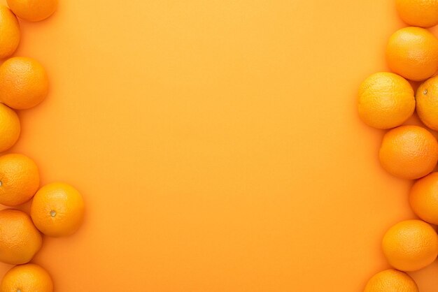 Photo directly above shot of oranges on yellow background