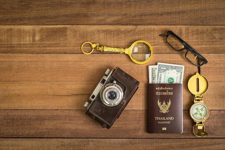 Photo directly above shot of passport with vintage camera on table